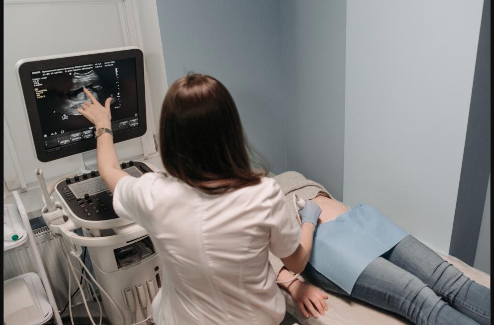Clinician performing an abdominal ultrasound exam, representing chronic kidney disease and electrolyte disorder assessment at Chinook Medical Centre Calgary