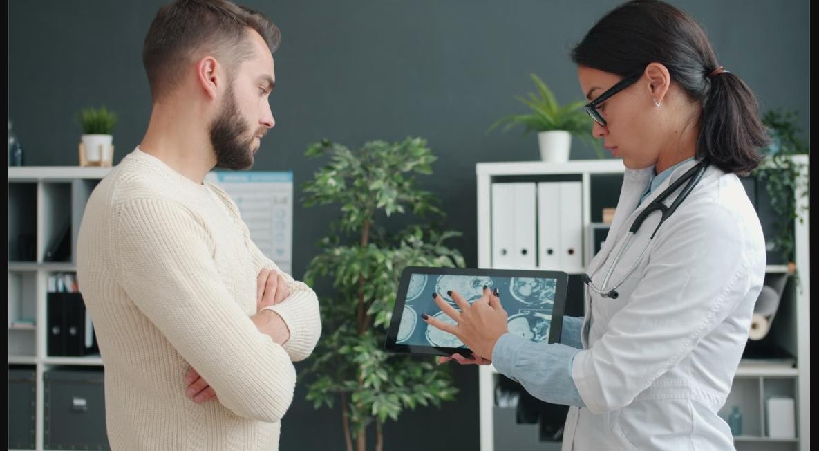Doctor explaining imaging results to a patient, representing fatty liver and liver condition assessment at Chinook Medical Centre Calgary